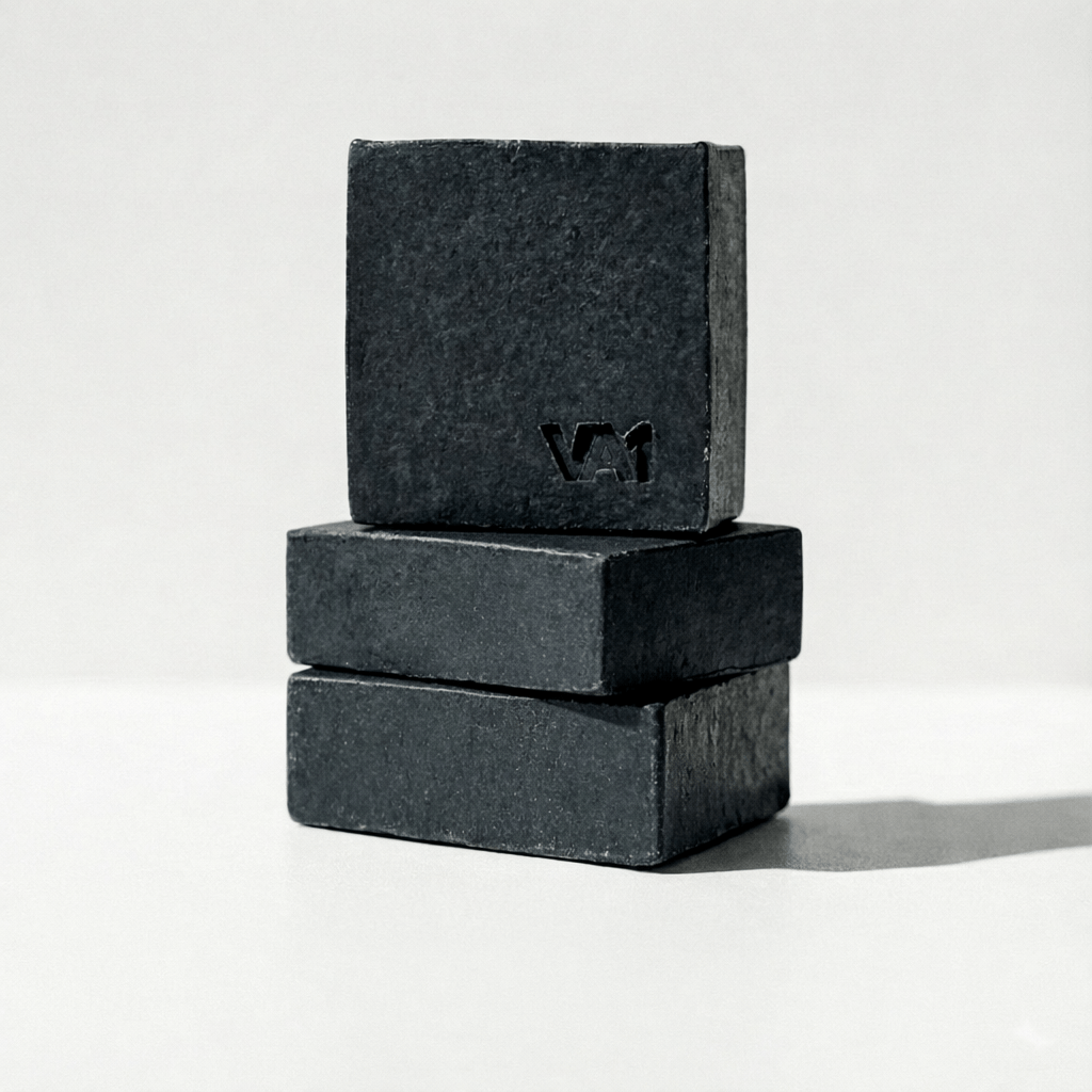 Gestapeltes 3er-Set der VA1 Core Bar. Detailansicht der fest gepressten Aktivkohle-Struktur und des Logos.