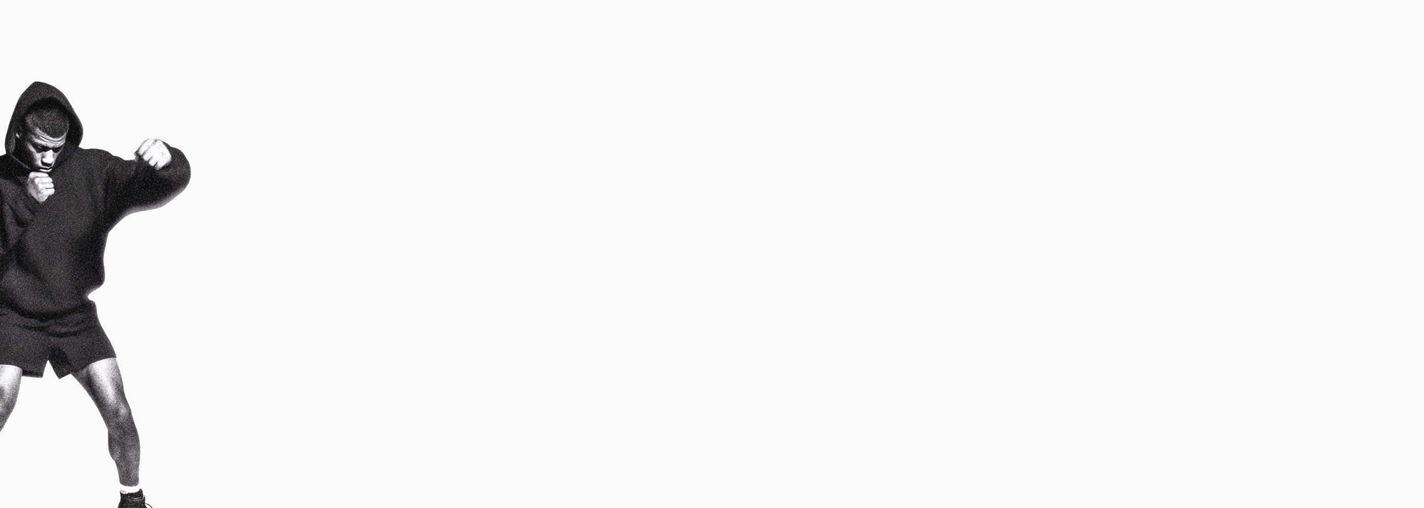 Desktop Header: Athlet beim Schattenboxen im Hoodie. Minimalistisches Design mit Fokus auf Kampfvorbereitung und Mat Defense Mindset.